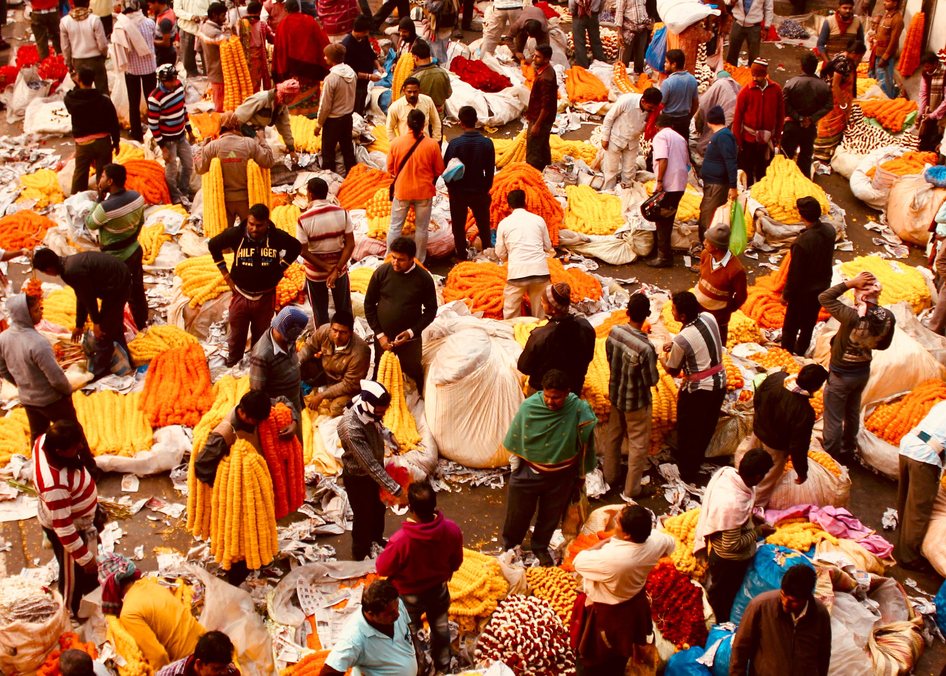 Bustling flower market from above showing crowds among colorful goods - vibrant local commerce travel photography